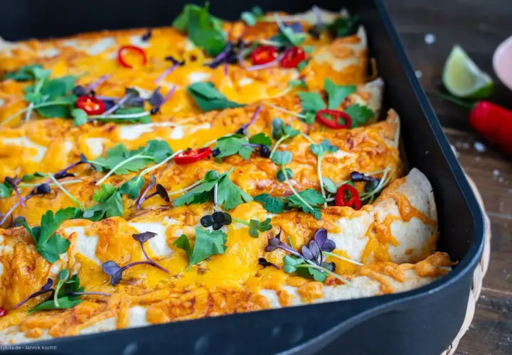 Herzhafte Enchiladas mit geschmolzenem Käse, garniert mit frischen Kräutern und Chilis. Ein köstliches Enchiladas Rezept für jeden Anlass.