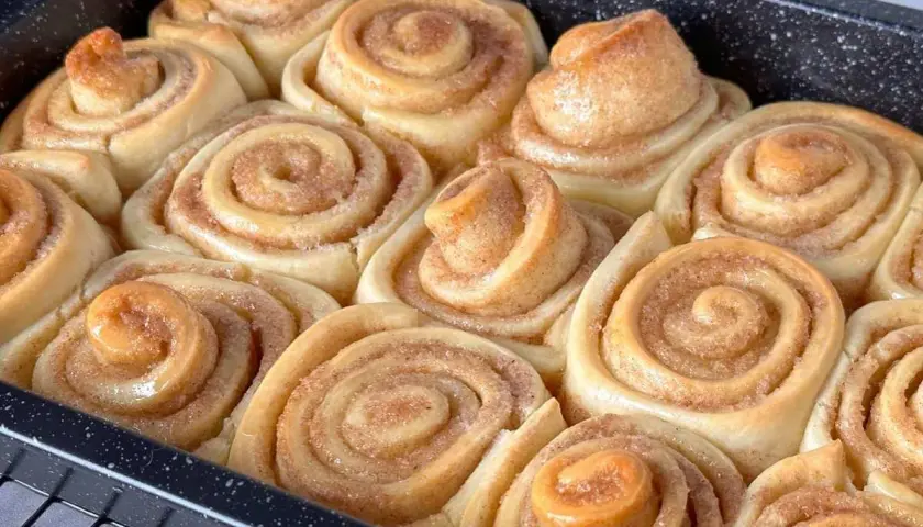 Frisch gebackene Zimtschnecken im Blech, bereit für das Zimtschnecken Rezept. Goldbraun und duftend.